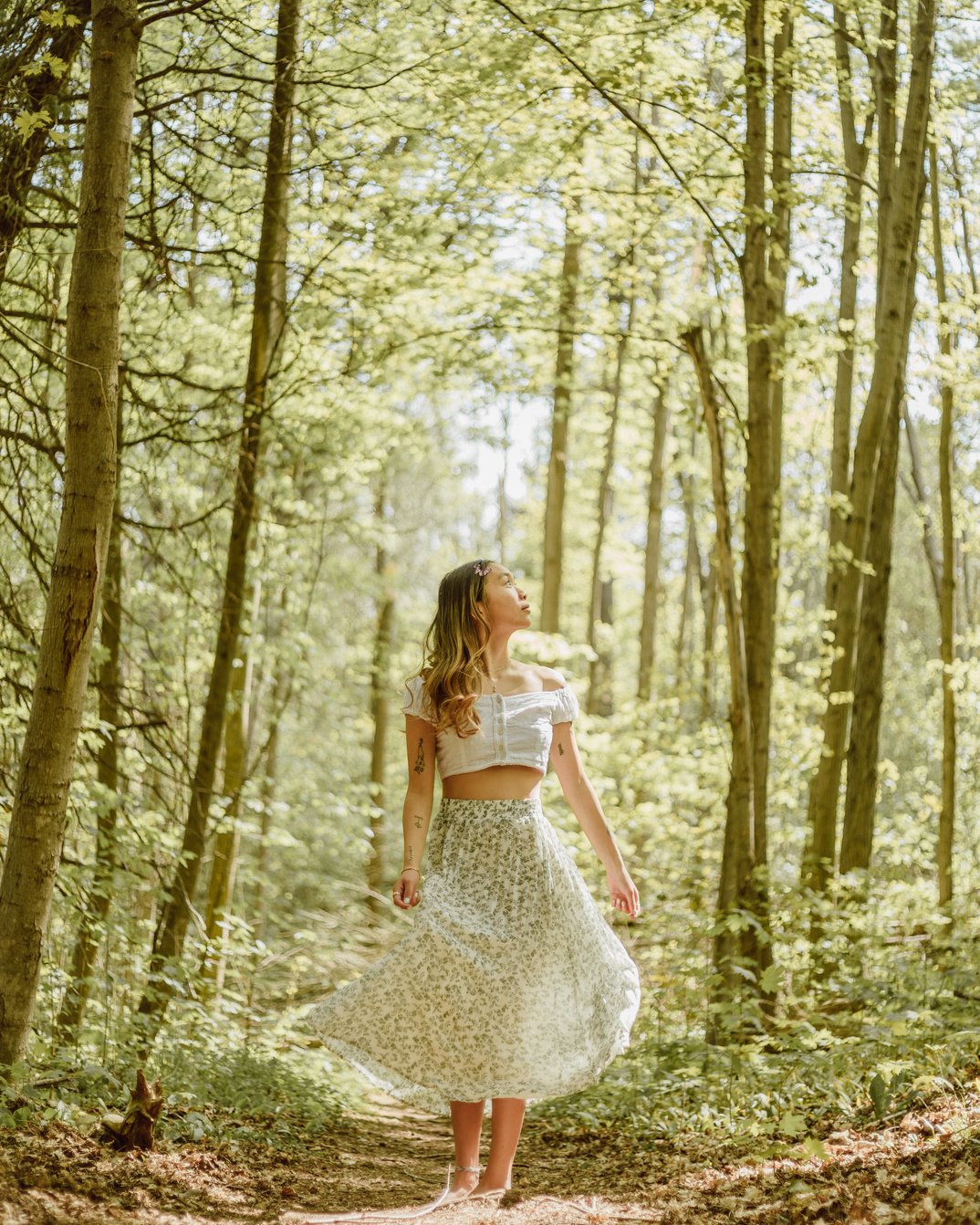 Asian woman admiring nature in forest